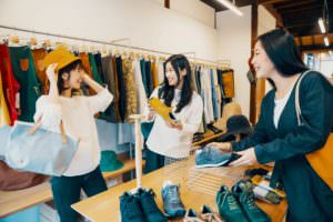 three women shopping in a retail store